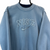 VINTAGE 90S NIKE SPELLOUT SWEATSHIRT IN BABY BLUE - MEN'S SMALL/WOMEN'S MEDIUM